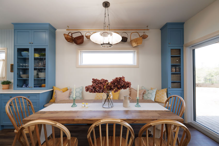 Dining table with bench seating and blue built-in cupboards designs