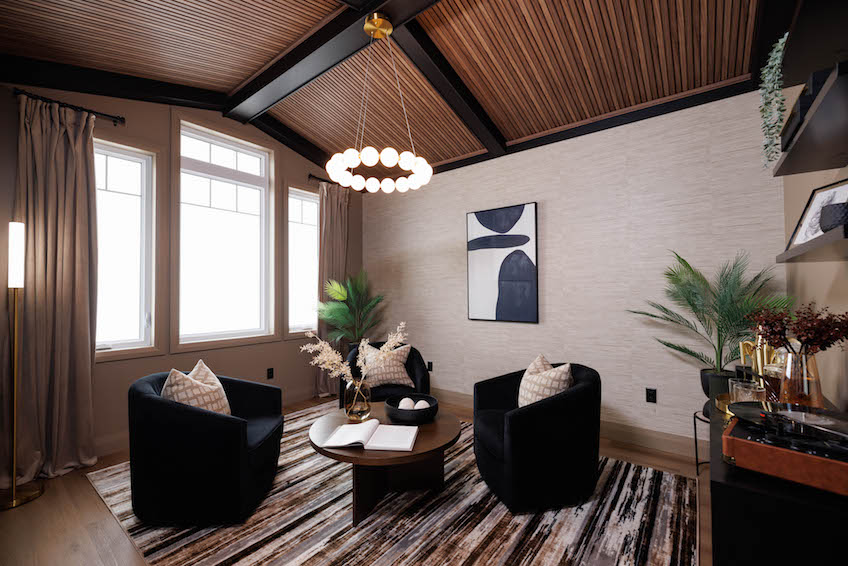 A frame living room with oversized chairs and hanging light